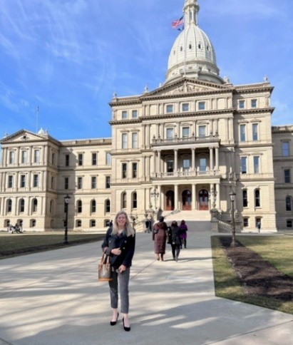 Karen Dunholter in front of MI State Capitol building