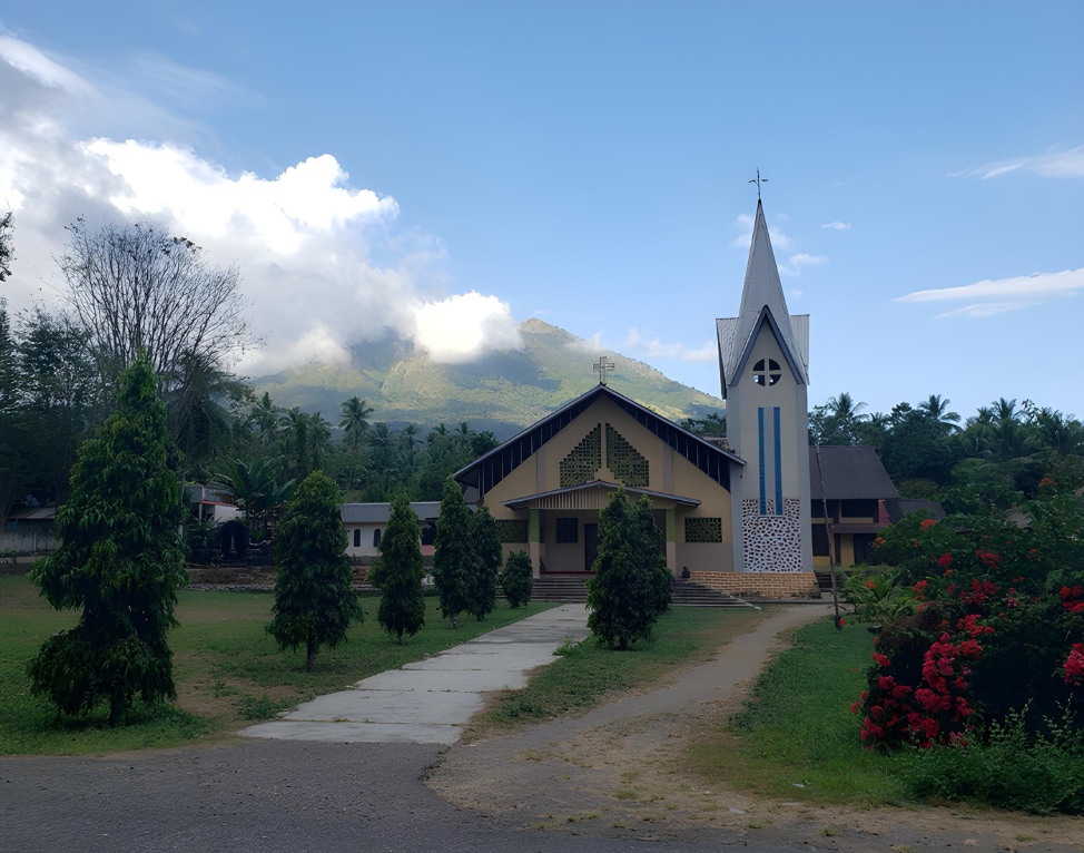 The local church with volcano Ile Boleng in the background