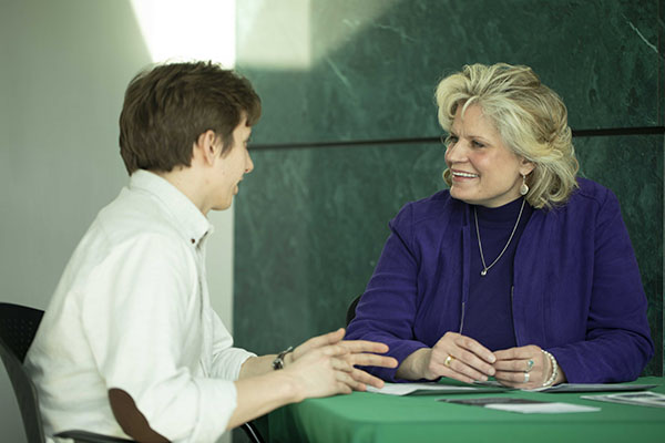 Craigen Oster, an advanced student in the Legal Advocacy for People with Cancer Clinic at Wayne Law, speaks with Kathryn Smolinski, founder and director of the clinic.