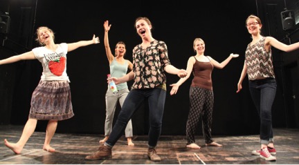 Five people dancing on a stage.