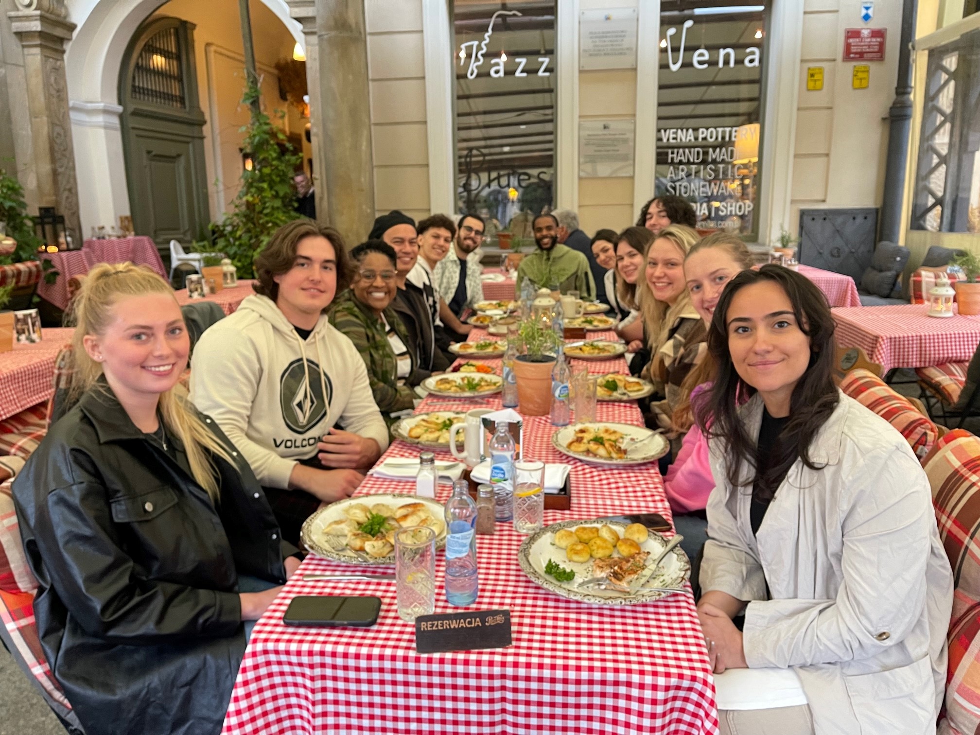 Students sitting around a table with plates of pierogi