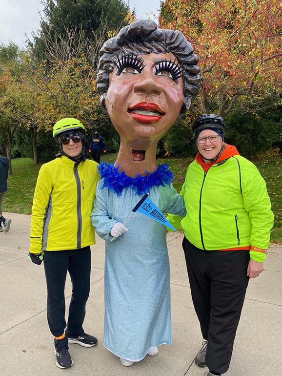 Branis Pesich (left) and Tracy Besek along side a giant Aretha Franklin at the Uniroyal Promenade grand opening in Detroit in October.