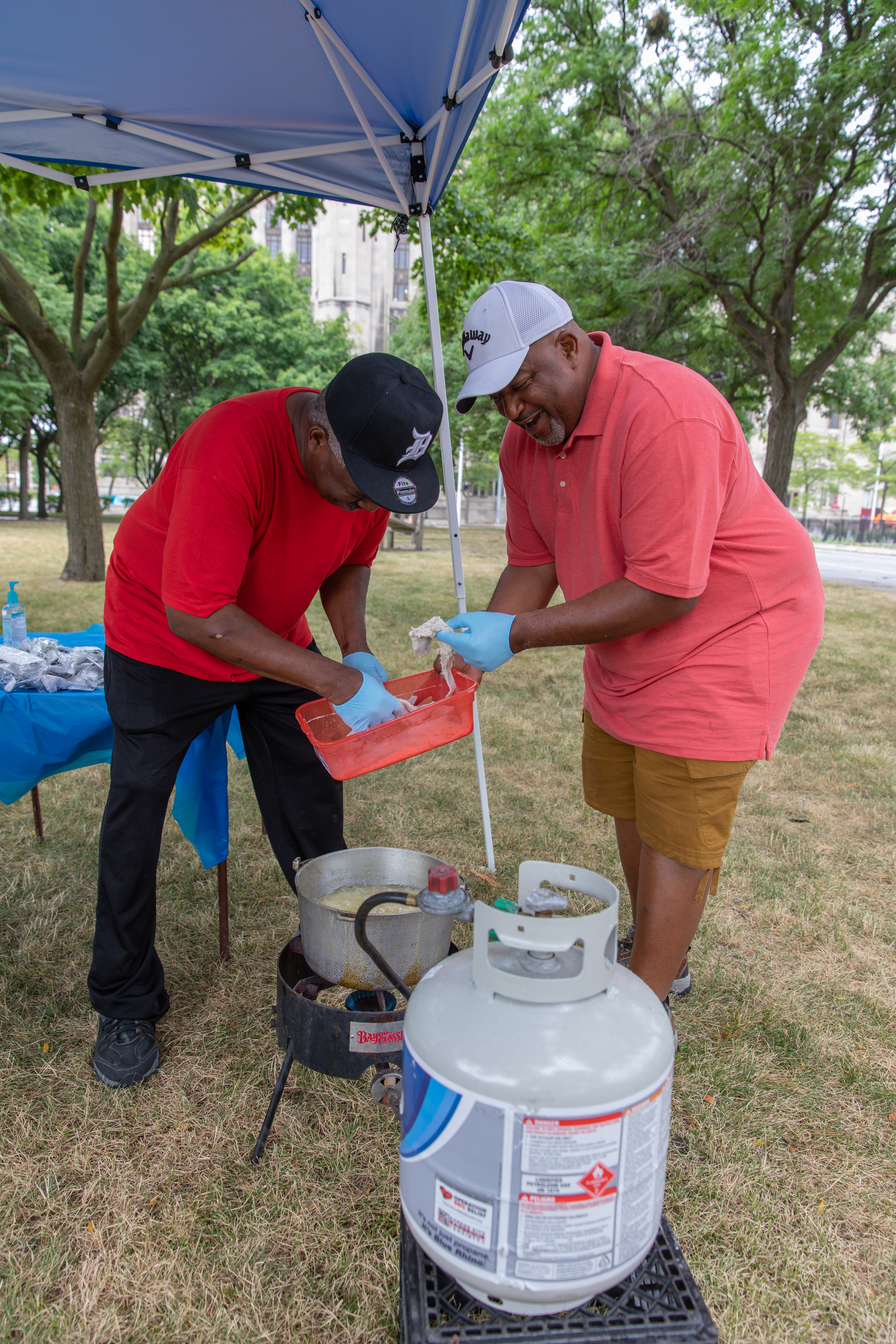 John Smith (right) helps prepare a meal in Detroit on July 21, 2018.