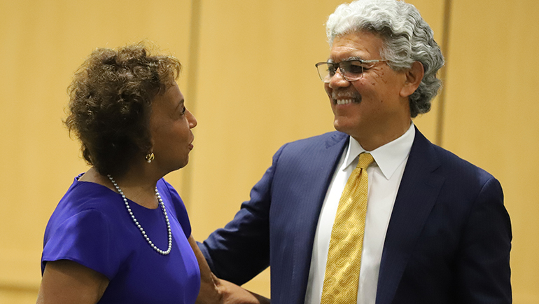 Former board member Denise Lewis and President M. Roy Wilson talk before the start of Thursday's Board of Governors meeting at Wayne State University.