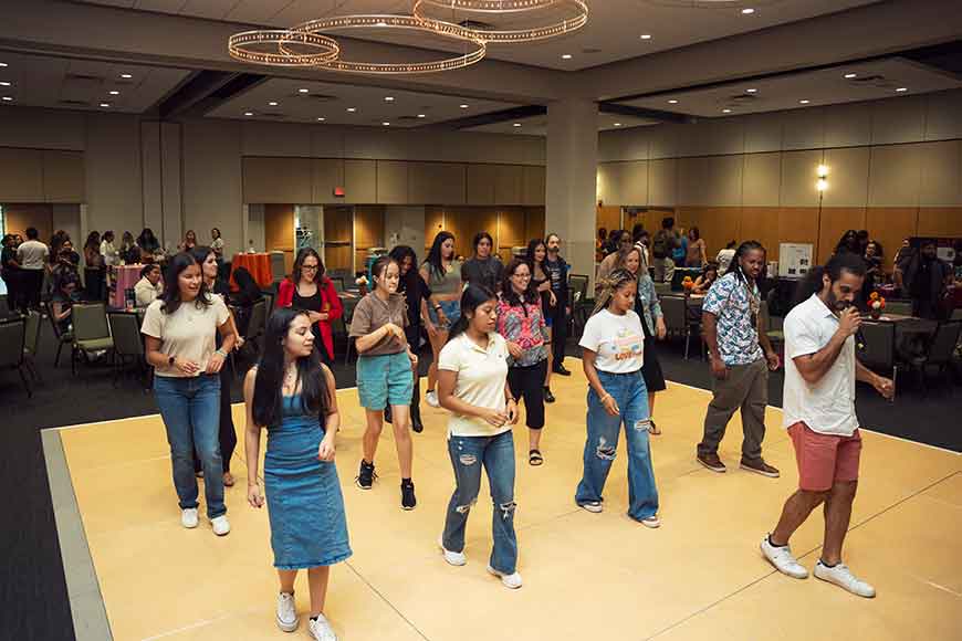 Attendees dancing at the 2024 Latino/a Faculty Staff Welcome Back reception.