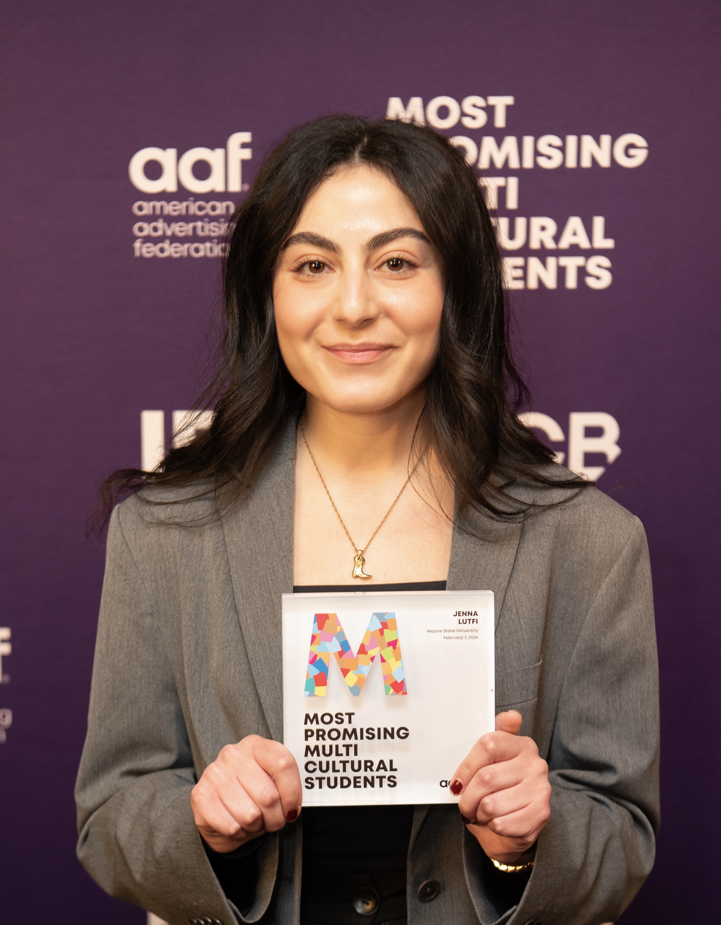 Woman holds an award in both hands