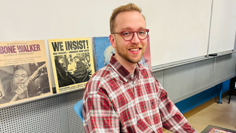 Senior Matthew Baube poses for a photo with his collection of jazz and blues records.