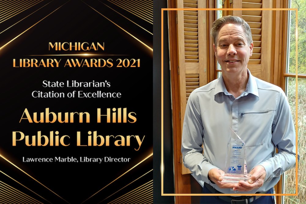 SIS alumnus Lawrence Marble is pictured with his Michigan Library Association Award