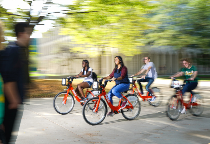  Students riding MoGo bikes on campus