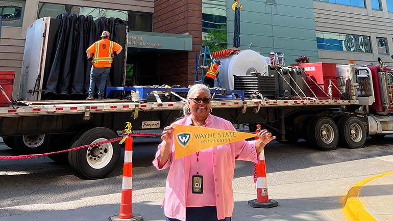 Angela Bumphus, a secretary IV in the Department of Pharmaceutical Sciences, celebrates the delivery of the new MRI scanner on May 17.