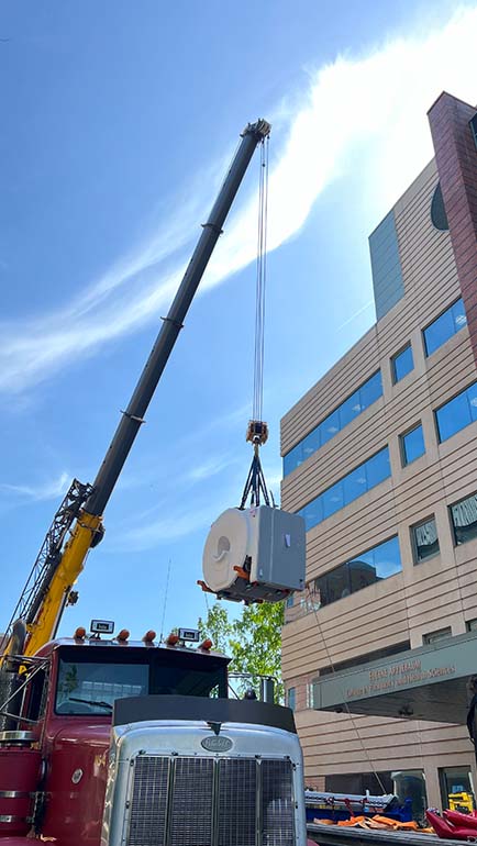 The new MRI scanner arrived at the Eugene Applebaum College of Pharmacy and Health Sciences on a flatbed tractor trailer and lifted by a crane on May 17.