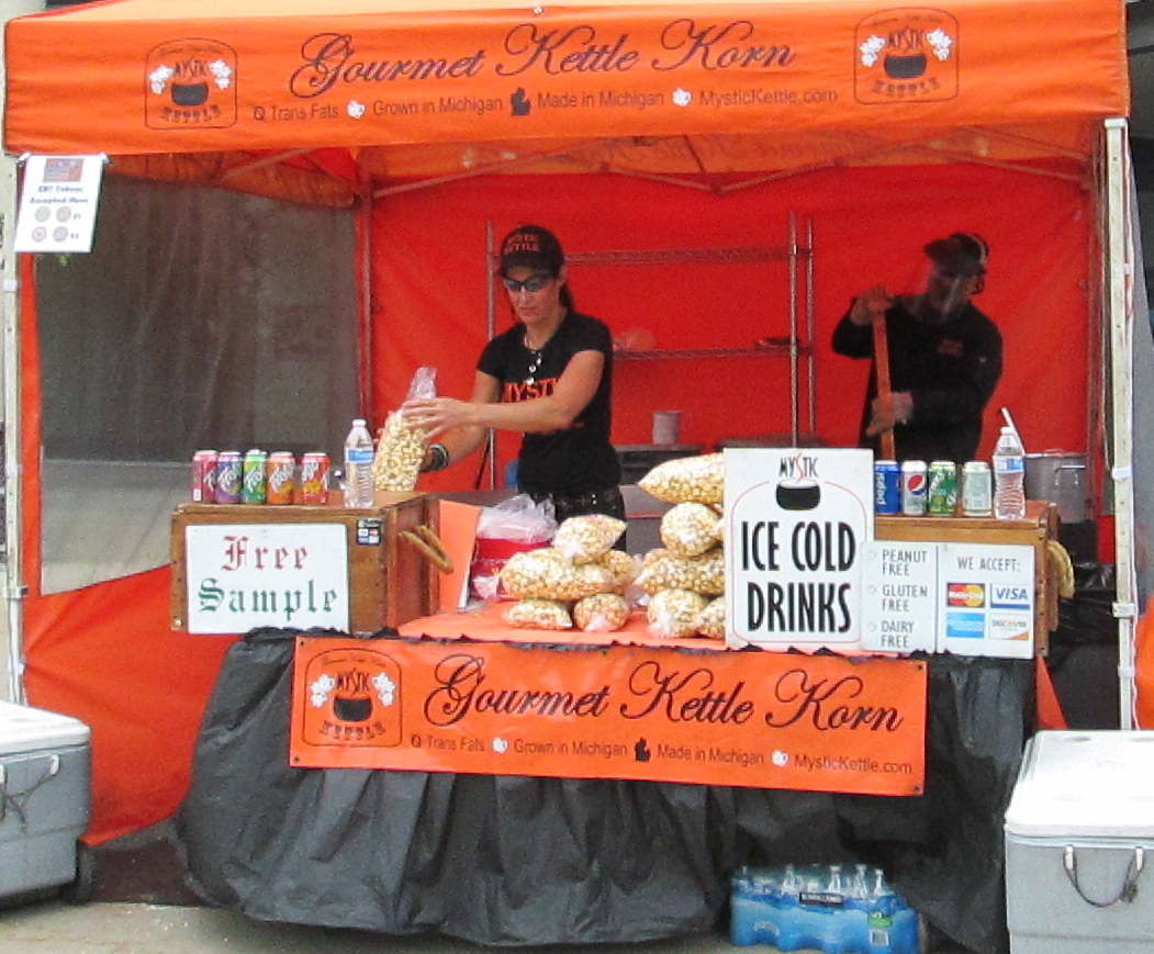 Kettle korn stand with workers making kettle korn