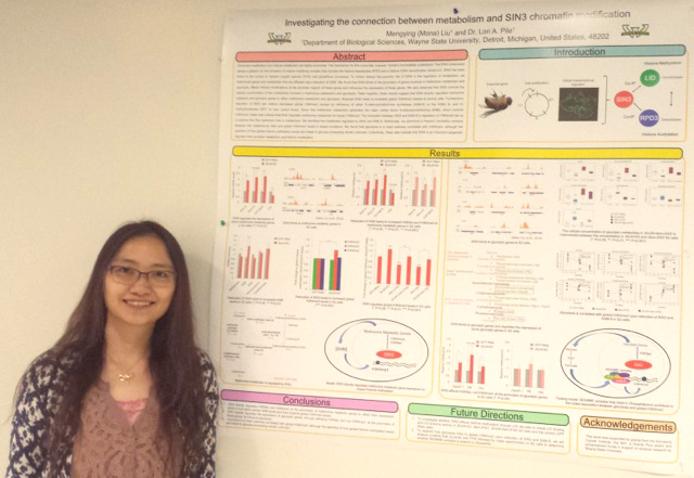 Mengying (Mona) Liu standing next to research poster.