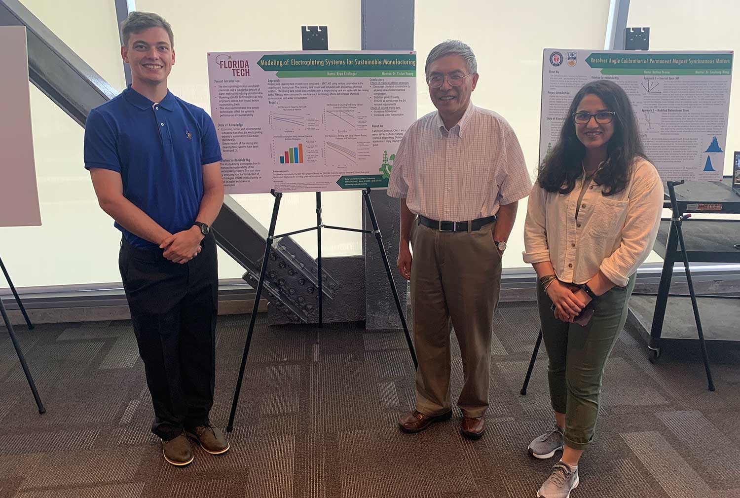 Professor Yinlun Huang with two students at the REU poster presentation.