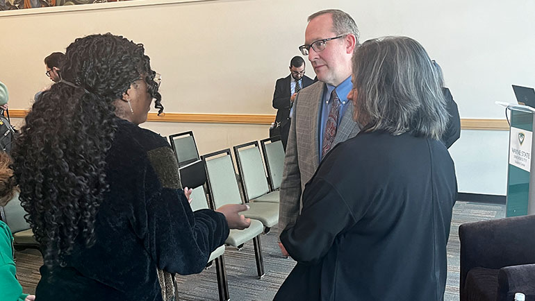 Wayne State student Adaure Iwuh (left) speaks with OPM acting director Rob Shriver following the federal government recruiting tour presentation at the Student Center Center Building on Oct. 9.