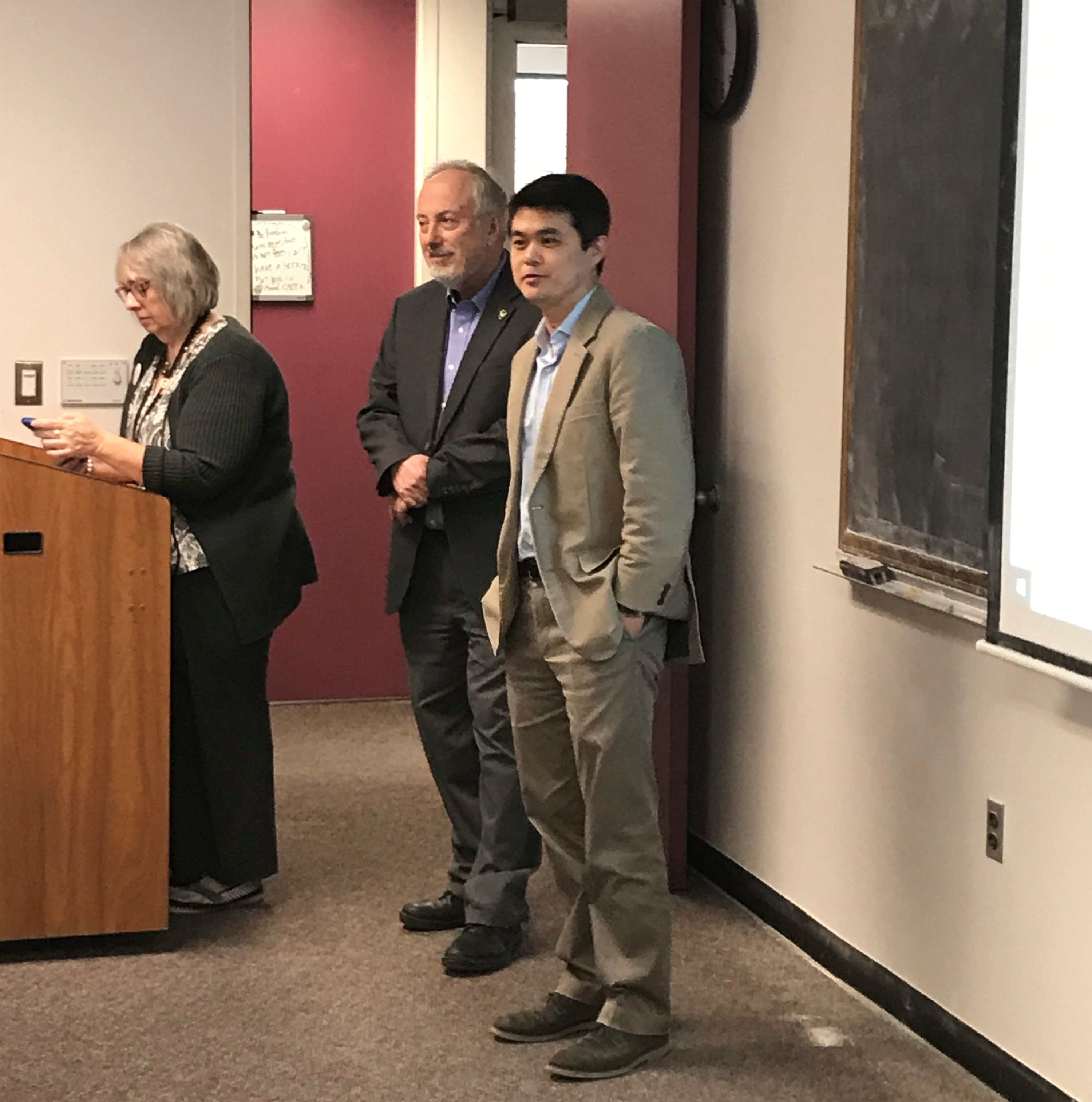 From left to right Academic Advisor Dr. Kimberly Morgan prepares her presentation, while Mathematics Department Chair Dr. Hengguang Li and Associate Department Chair Dr. Daniel Drucker prepare to welcome the students.