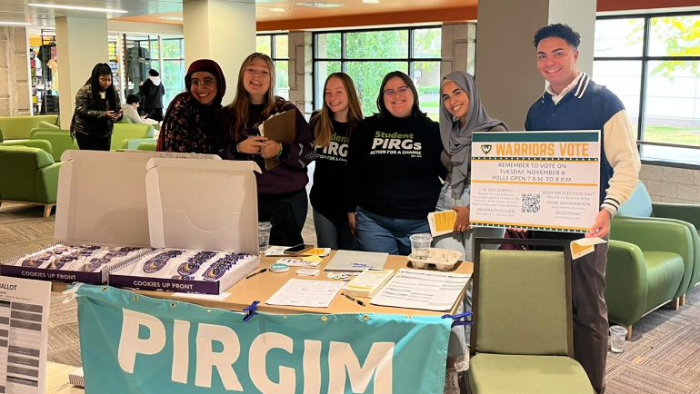 Members of the Wayne State PIRGIM Campus Action group share election resources in the Student Center.