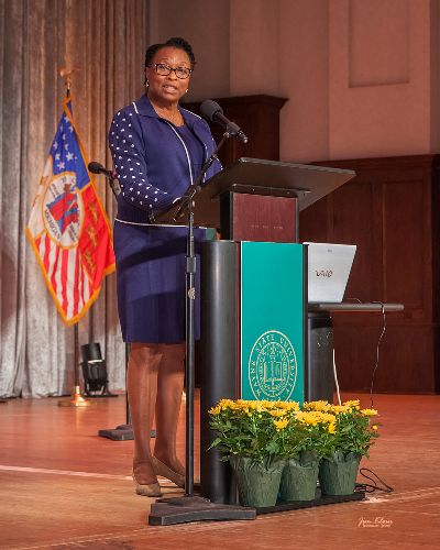 Daphne W. Ntiri standing at a podium.