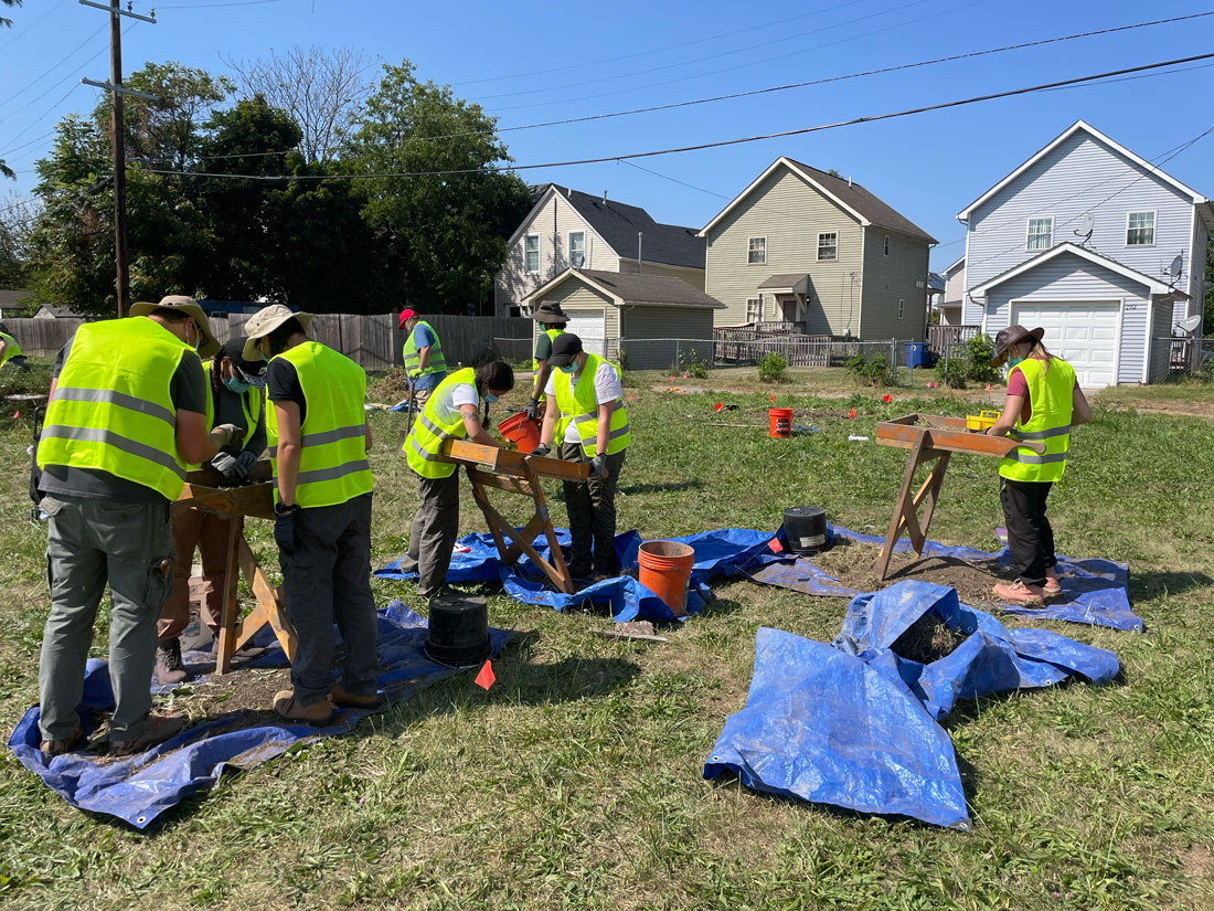 Students working in field excavating artifacts