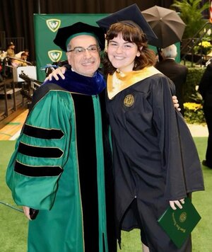 Taima and Ahmad Ezzeddine hugging after graduation 