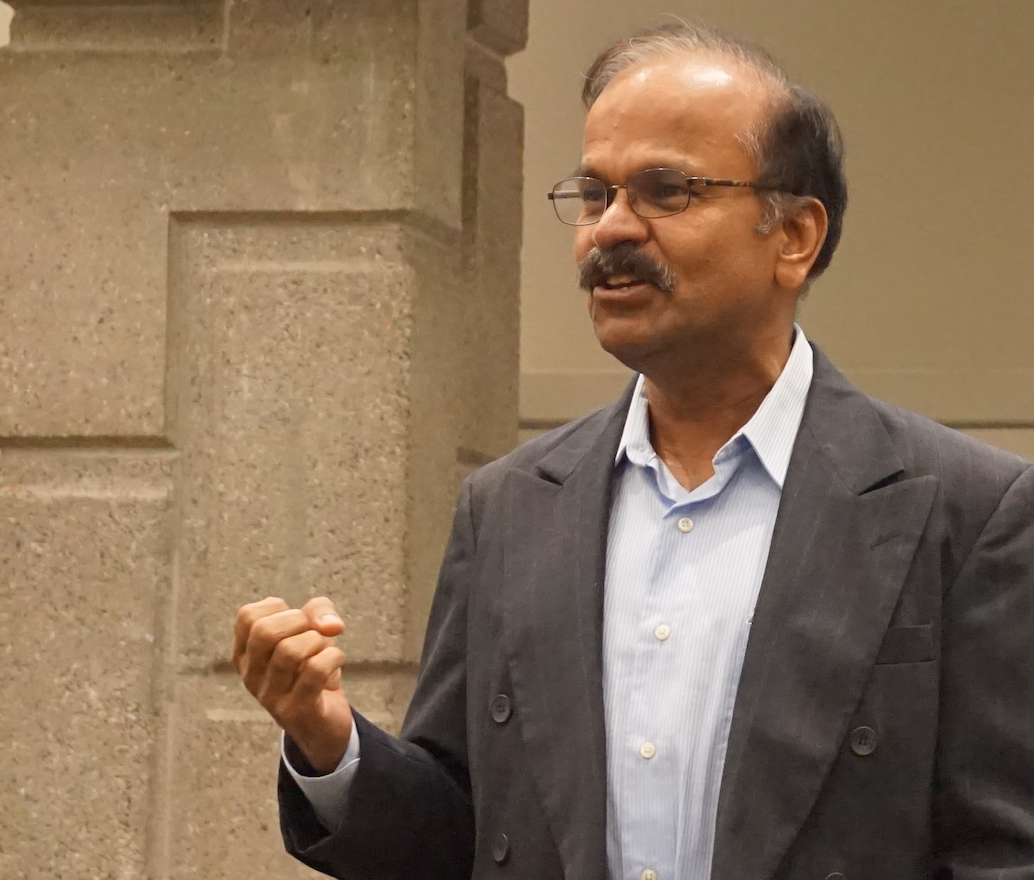 Mark Baskaran speaking in front of crowd