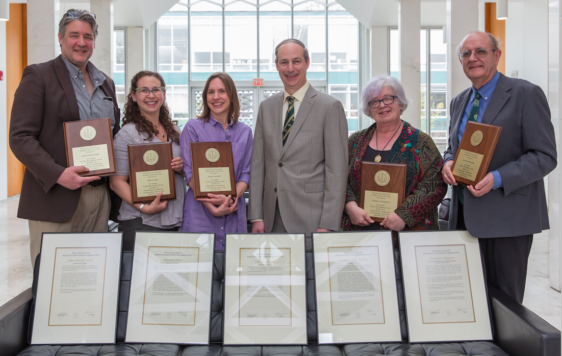 Faculty posing with awards.