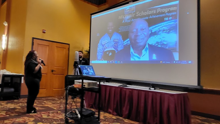 McNair Scholar Shaqyna Ross speaks with Carl McNair, Ronald McNair's brother, about her experience in the program at a conference in Wisconsin Dells.
