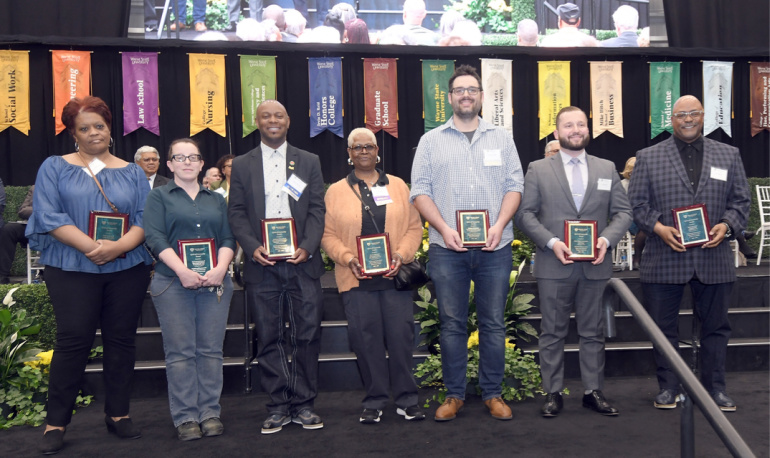 The Wayne State Spirit of Community Award recipients pose for a photo on the stage at the Employee Recognition Ceremony.