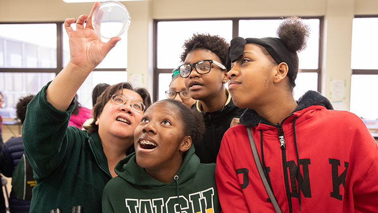 High school students get a view of a petri dish in a lab during Wayne State’s STEM Day in 2019.