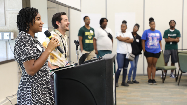 Rocket Companies software engineers Gerrae Jackson (left) and Blake Shaw (second from left) lead an interactive session in which Tech On-Ramps participants drafted their own AI chatbots.