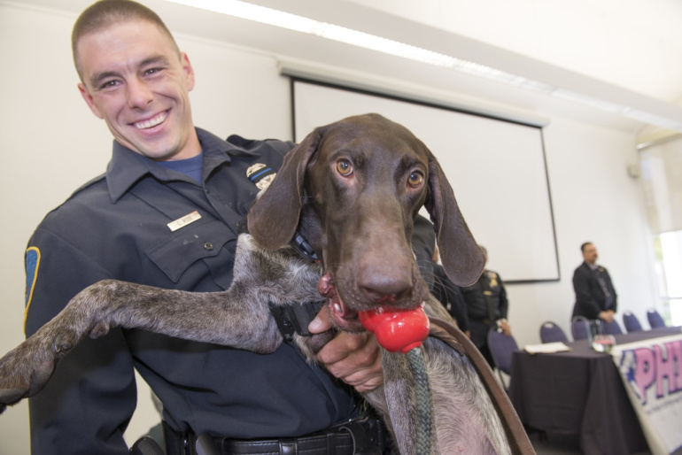 Sgt. Collin Rose is seen with his K-9 dog Vapor.