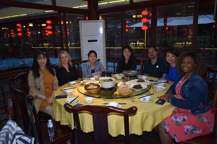 Professor Yan and students at dinner in China