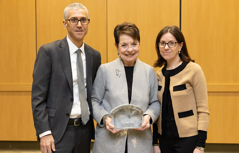 Elaine Driker (center) holds up the Eugene Driker Award for Distinguished Service. Elaine Driker along with their son Stephen Driker (left) and his wife Jennifer were on hand to receive the award in Eugene's honor.