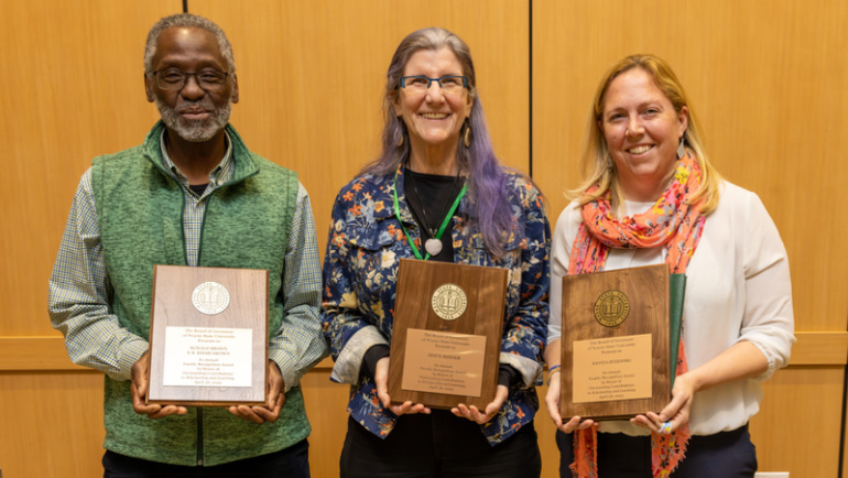 Ronald Brown (left), Loraleigh Keashly (middle) and Krysta Ryzewski (right) hold up their 2023 Board of Governors Faculty Recognition Awards.