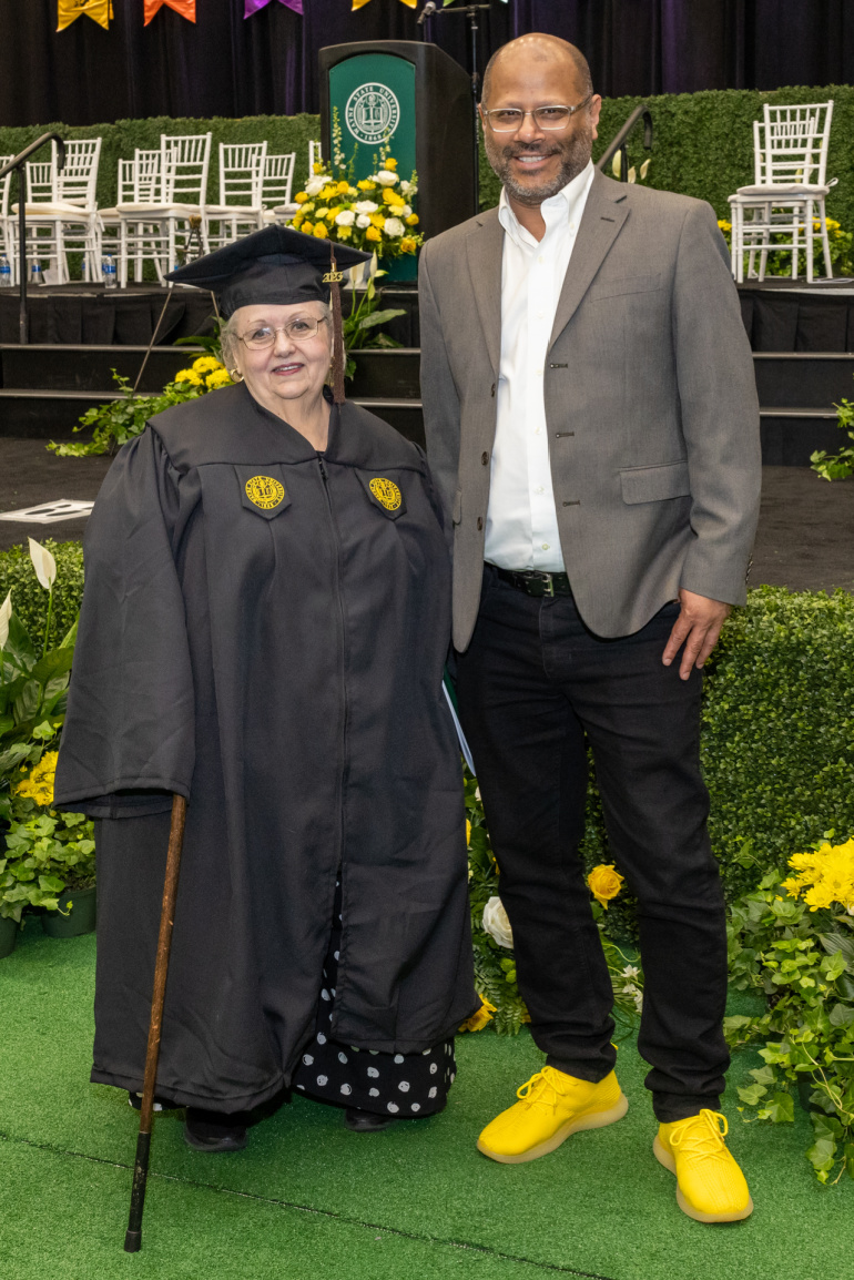 Linda Ignagni (left) poses for a photo with CFPCA Dean Hasan Elahi at the May commencement ceremonies.