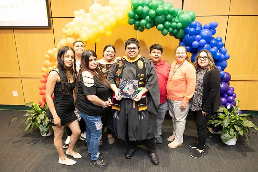 A graduating Warrior with their family at the 2024 Wayne State University Rainbow Graduation