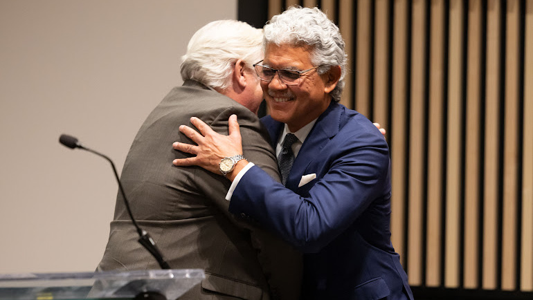 Wayne State President Emeritus M. Roy Wilson (right) hugs Wayne State Board of Governors Chair Mark Gaffney at the M. Roy Wilson State Hall dedication.
