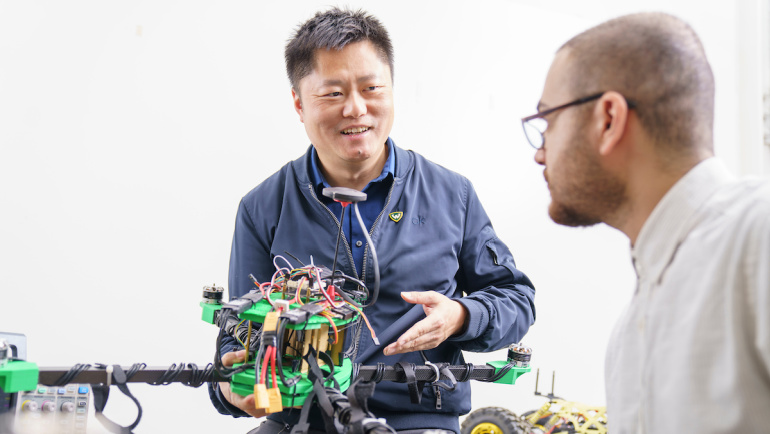 A Wayne State professor works with a student in an engineering research lab.