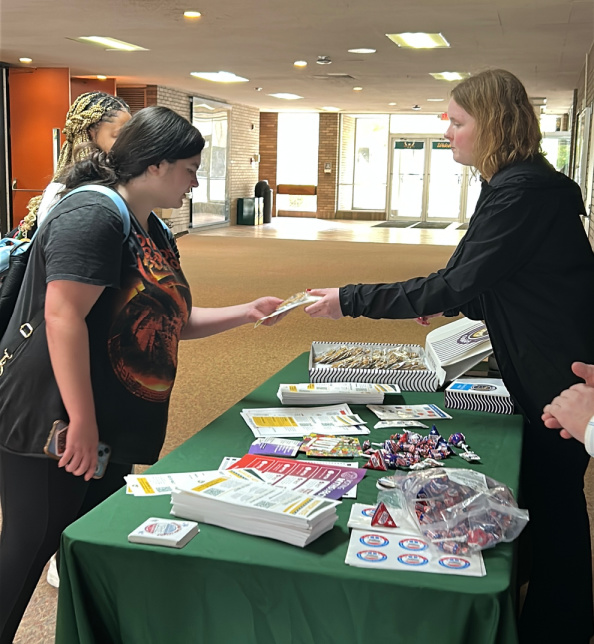 Cordelia Kraewski shares election resources with another student on campus.