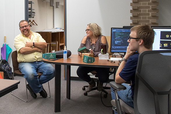 Gary Cendrowski (left), Melissa Crabtree and Eric Chapiewski discuss the new Wayne State Virtual Experience app in the VR workspace at Computing, Friday, Sept. 21, 2018.