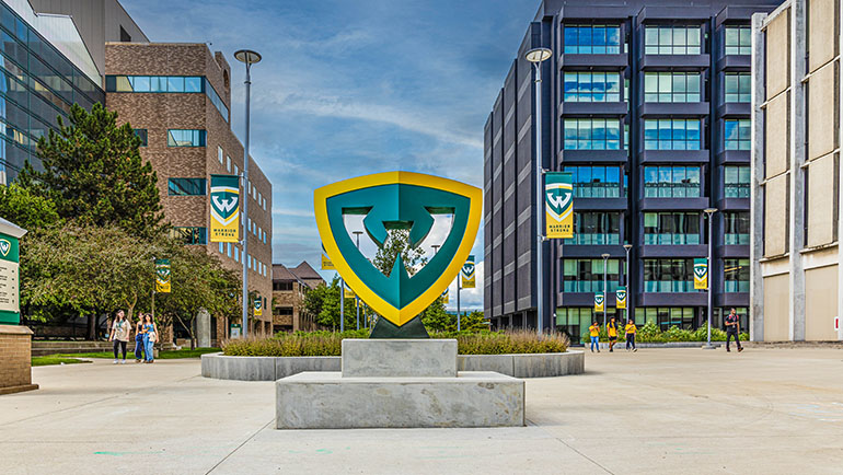 Logo sign at the entrance to Wayne State campus.