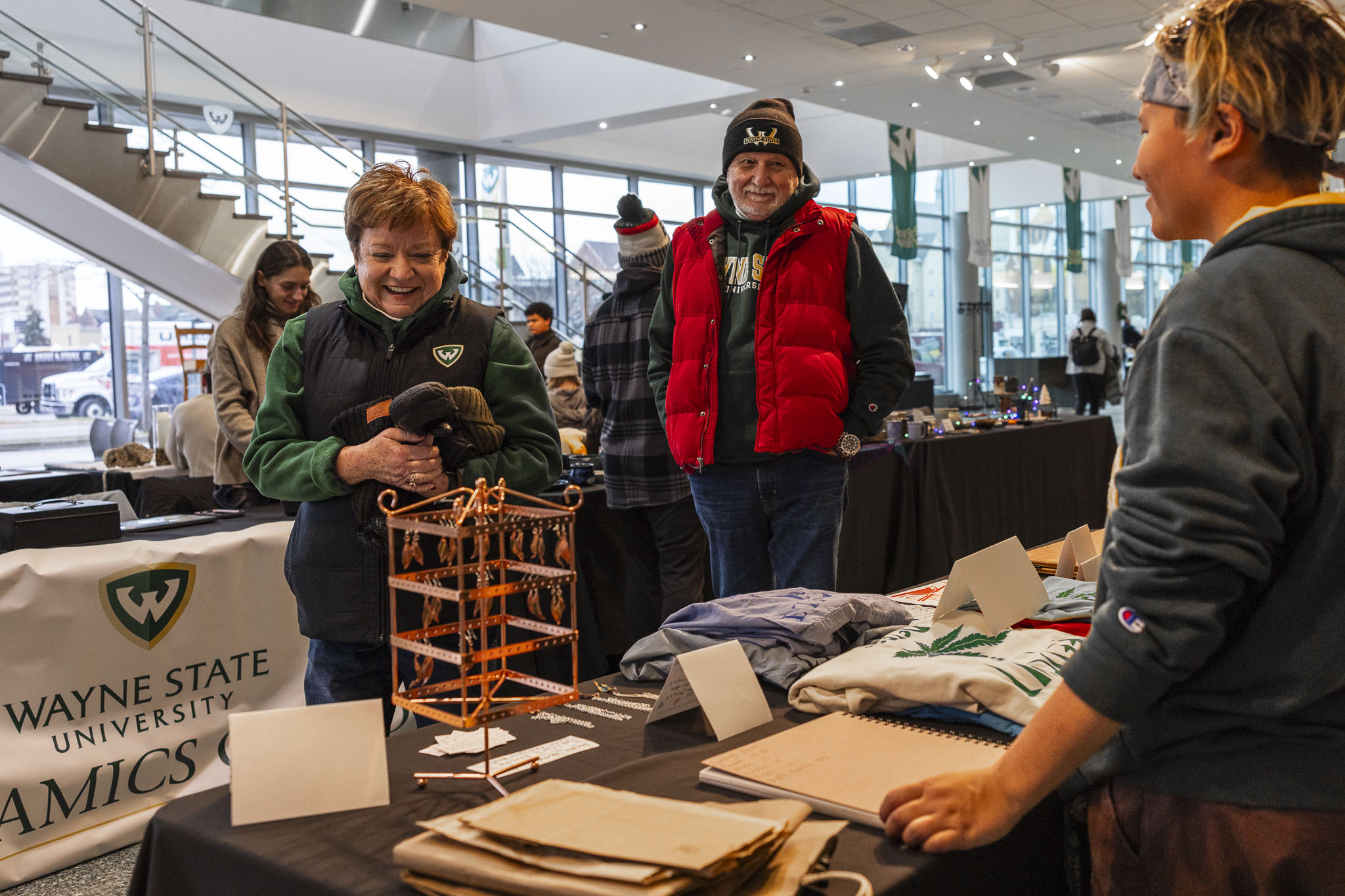 Laurie Lauzon Clabo, Ph.D. of Wayne State University looks at a jewelry display of copper earrings