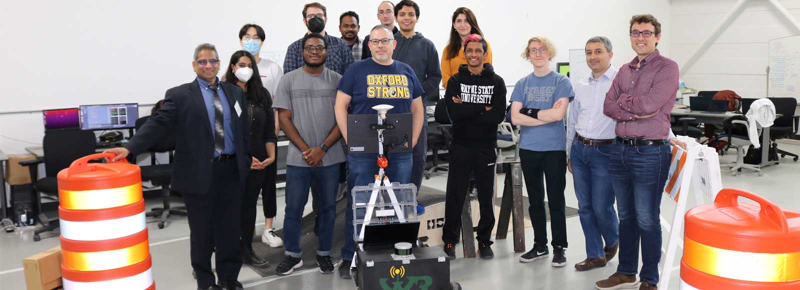 Members of the Warrior Robotics team with their robot in the lab