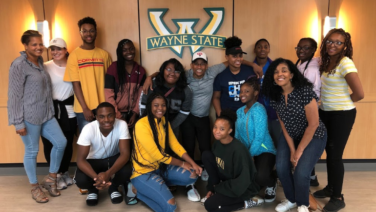 Actor/author Hill Harper poses with rising high school freshmen inside Wayne State's Student Center Building