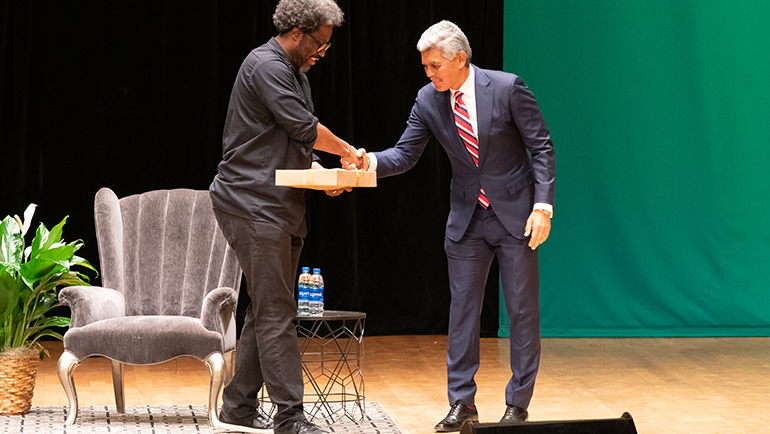 W. Kamau Bell receives gift from M. Roy Wilson