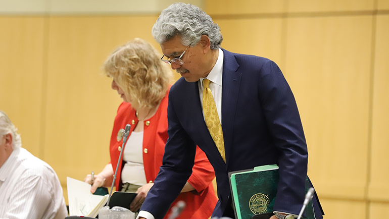 M. Roy Wilson arrives for his final Board of Governors meeting as president of Wayne State University.