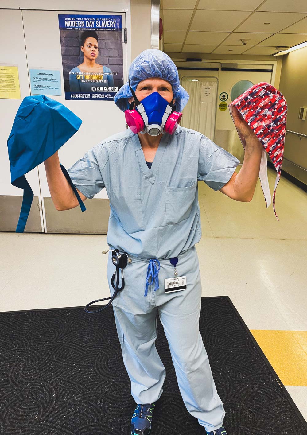 Health worker holding surgical masks.