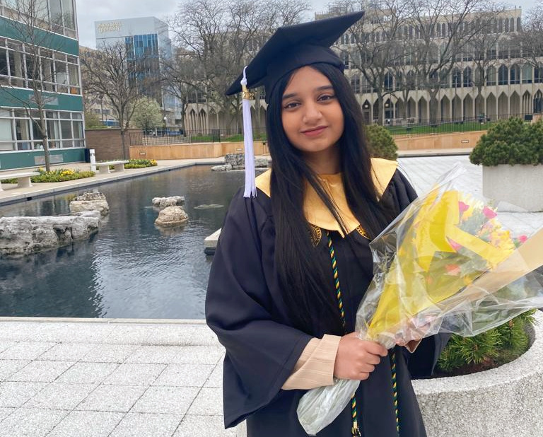 Zarin Farook poses for a photo in her cap and gown.